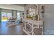 Bright entryway with decorative console table and mirror, leading to dining area and backyard view at 311 Coronado Ave # 62, Matthews, NC 28104