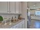 Kitchen features granite countertops and white cabinets with a built-in wine rack at 311 Coronado Ave # 62, Matthews, NC 28104