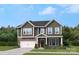 Two-story house with gray siding and a two car garage at 311 Coronado Ave # 62, Matthews, NC 28104