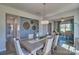 Bright dining room with a large table and view into the kitchen and Gathering room at 311 Coronado Ave # 62, Matthews, NC 28104