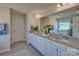 Double vanity bathroom with granite countertop and large mirror at 311 Coronado Ave # 62, Matthews, NC 28104