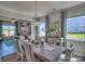 Spacious dining room with large windows and a farmhouse-style table at 311 Coronado Ave # 62, Matthews, NC 28104