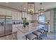 Island kitchen with granite countertops, white cabinets, and pendant lighting at 311 Coronado Ave # 62, Matthews, NC 28104