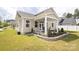 Home's backyard features a covered patio and well-manicured landscaping at 14217 Ridgewater Way, Charlotte, NC 28278
