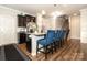 Kitchen features a breakfast bar with blue stools and stainless steel appliances at 14217 Ridgewater Way, Charlotte, NC 28278