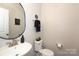 Modern powder room with pedestal sink and toilet at 14217 Ridgewater Way, Charlotte, NC 28278
