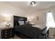 Well-lit bedroom with black furniture and large window at 14217 Ridgewater Way, Charlotte, NC 28278