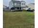 Two-story house with gray siding, attached garage, and a spacious front yard at 406 Smokehouse Ln, Albemarle, NC 28001