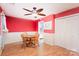 Dining room with hardwood floors, a round wooden table, and red walls at 8017 Regent Park Ln, Charlotte, NC 28210
