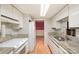 Kitchen with granite countertops, stainless steel sink, and white cabinets at 8017 Regent Park Ln, Charlotte, NC 28210