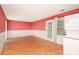 Living room with hardwood floors, red walls, and sliding glass doors at 8017 Regent Park Ln, Charlotte, NC 28210