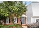 Brick townhome with a landscaped yard and gray front door at 8017 Regent Park Ln, Charlotte, NC 28210