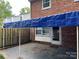 Backyard patio area covered by a blue tarp at 8017 Regent Park Ln, Charlotte, NC 28210