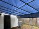 Backyard patio with blue tarp cover and exterior access at 8017 Regent Park Ln, Charlotte, NC 28210