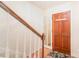 Entryway with hardwood floors, staircase, and a full-length mirror at 8017 Regent Park Ln, Charlotte, NC 28210