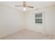 Simple bedroom featuring carpet, window, and ceiling fan at 8017 Regent Park Ln, Charlotte, NC 28210
