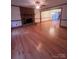 Spacious living room with hardwood floors, a brick fireplace, and a ceiling fan at 1409 Trinity Church Rd, Monroe, NC 28112