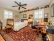 Cozy bedroom with hardwood floors, a ceiling fan, and built-in shelving at 325 Rosemary Ln, Gastonia, NC 28054