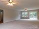 Spacious living room with carpeting and access to the deck at 8885 Brandon Cir, Concord, NC 28025