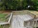 Elevated wooden deck with stairs leading down to the yard at 8885 Brandon Cir, Concord, NC 28025