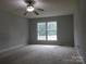 Spacious bedroom with large window and ceiling fan at 8885 Brandon Cir, Concord, NC 28025