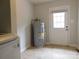 Laundry area featuring a water heater and exterior access at 8885 Brandon Cir, Concord, NC 28025