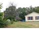 Yellow ranch home with red shutters and a large tree at 8885 Brandon Cir, Concord, NC 28025