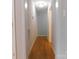 Long hallway with hardwood floors and neutral walls at 8885 Brandon Cir, Concord, NC 28025