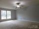 Spacious bedroom with ceiling fan and large windows at 8885 Brandon Cir, Concord, NC 28025