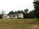 Ranch style home with a yellow exterior and red shutters at 8885 Brandon Cir, Concord, NC 28025
