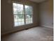 Spacious bedroom with large windows and neutral carpeting at 8885 Brandon Cir, Concord, NC 28025