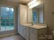 Bathroom with vanity, large mirror and window at 8885 Brandon Cir, Concord, NC 28025