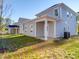 View of house exterior showcasing a two-story home and backyard at 560 Geneva Cir, Gastonia, NC 28056