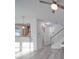 Bright living room with hardwood floors, open concept layout, and staircase at 560 Geneva Cir, Gastonia, NC 28056