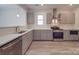 Modern kitchen with gray cabinets, quartz countertops, and stainless steel appliances at 560 Geneva Cir, Gastonia, NC 28056