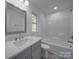 Clean bathroom with a bathtub, toilet, and vanity with quartz countertop at 560 Geneva Cir, Gastonia, NC 28056