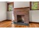 Brick fireplace with a dark stone hearth at 2523 Kool Park Ne Rd, Hickory, NC 28601
