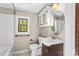 Bathroom with tub, toilet, and updated vanity at 2523 Kool Park Ne Rd, Hickory, NC 28601