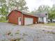 View of a home's detached garage with a double door and side door at 1918 Waxhaw Hwy, Monroe, NC 28112