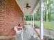 Covered front porch with brick columns and ceiling fan at 1918 Waxhaw Hwy, Monroe, NC 28112