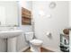 Updated bathroom with pedestal sink, toilet, and decorative wall accents at 9229 Bluefield St, Charlotte, NC 28273