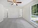 Bright bedroom with carpet, large window, and access to bathroom and closet at 325 Pelling Dr, York, SC 29745