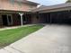 Home's back exterior showcasing patio, carport, and landscaping at 900 Nance St, Kannapolis, NC 28083