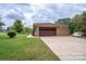 Attached garage with a brown door and concrete driveway at 900 Nance St, Kannapolis, NC 28083