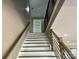 Modern staircase with a sleek metal and wood railing at 1243 10Th Street Nw Pl, Hickory, NC 28601