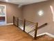 Modern hallway with hardwood floors and a sleek metal railing at 1243 10Th Street Nw Pl, Hickory, NC 28601