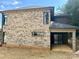 Side view of the house showcasing brick exterior and patio at 1243 10Th Street Nw Pl, Hickory, NC 28601