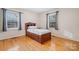 Bedroom with hardwood floors, neutral walls, and two windows at 2808 Findley Rd, Statesville, NC 28625