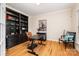 Home office features built-in shelving and hardwood floors at 8127 Caliterra Dr, Charlotte, NC 28227