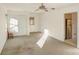 Living room featuring carpet, ceiling fan, and built-in shelving at 1860 Rosemont St, Salisbury, NC 28144